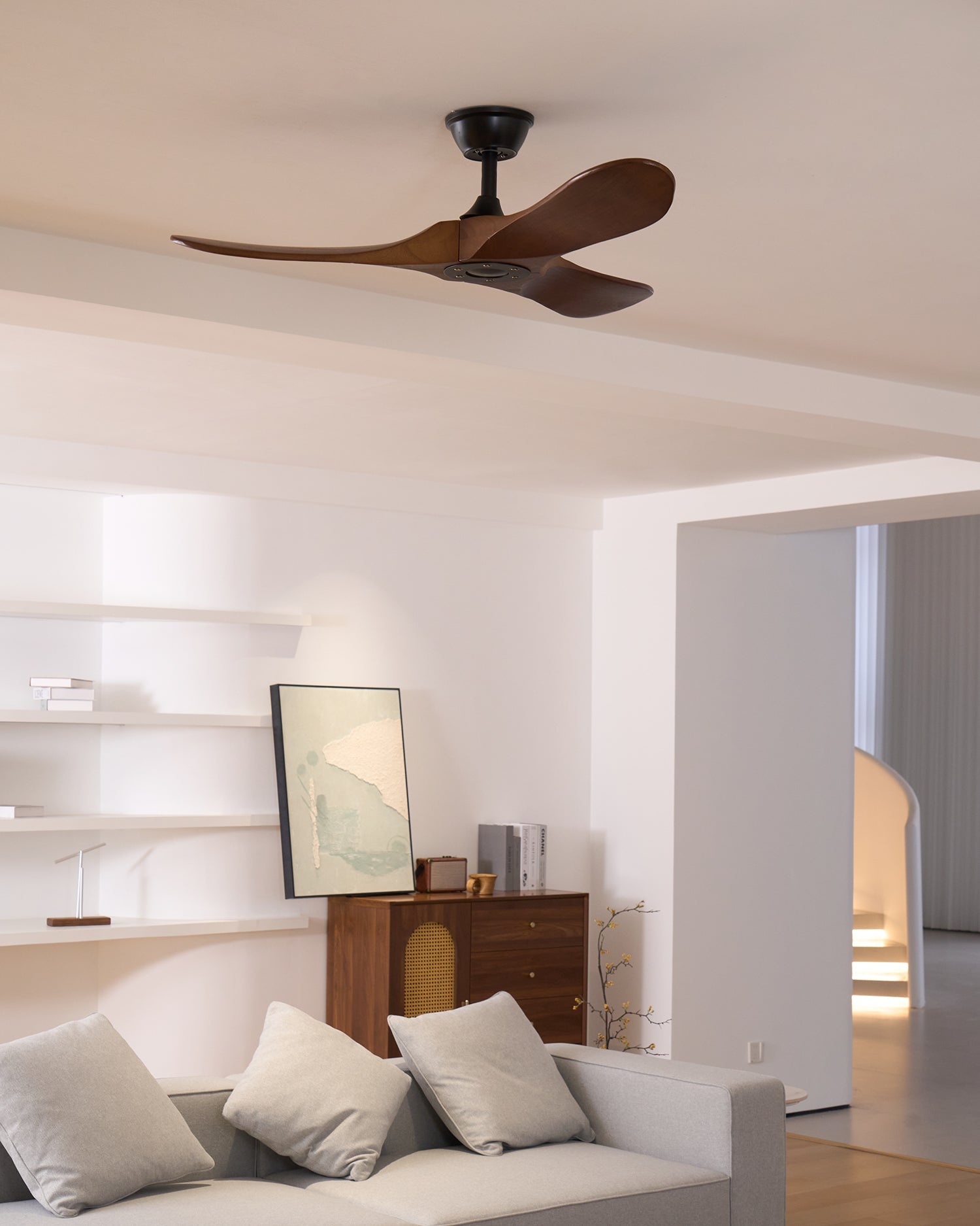 Wooden propeller ceiling fan shown from below on white