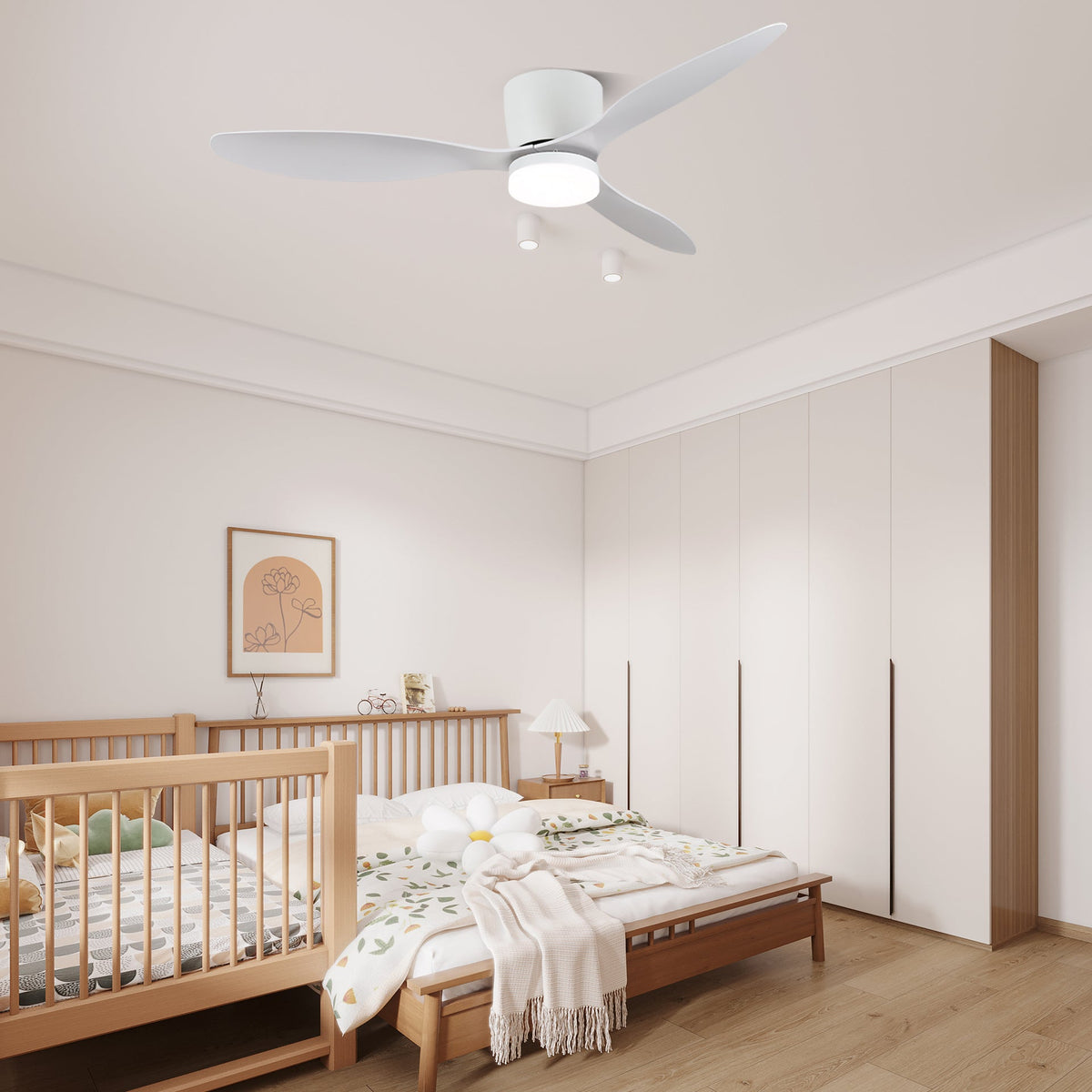 Wide white blades turn on this Clérachic ceiling fan, glowing warm above a nursery with a wooden crib.