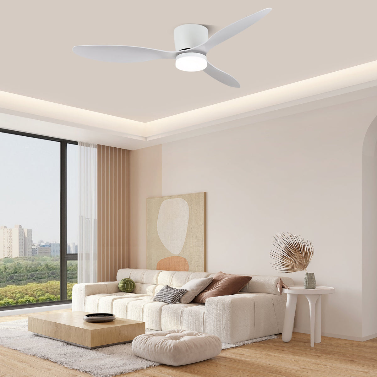 Wide white blades spin on this Clérachic ceiling fan, glowing warm along a crown-lit ceiling above a cream sofa and city view.
