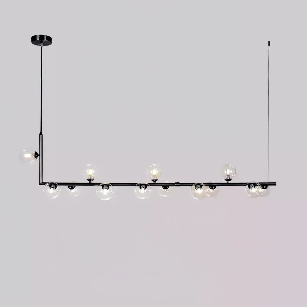 Clear glass pendant light close-up showing globe and steel join