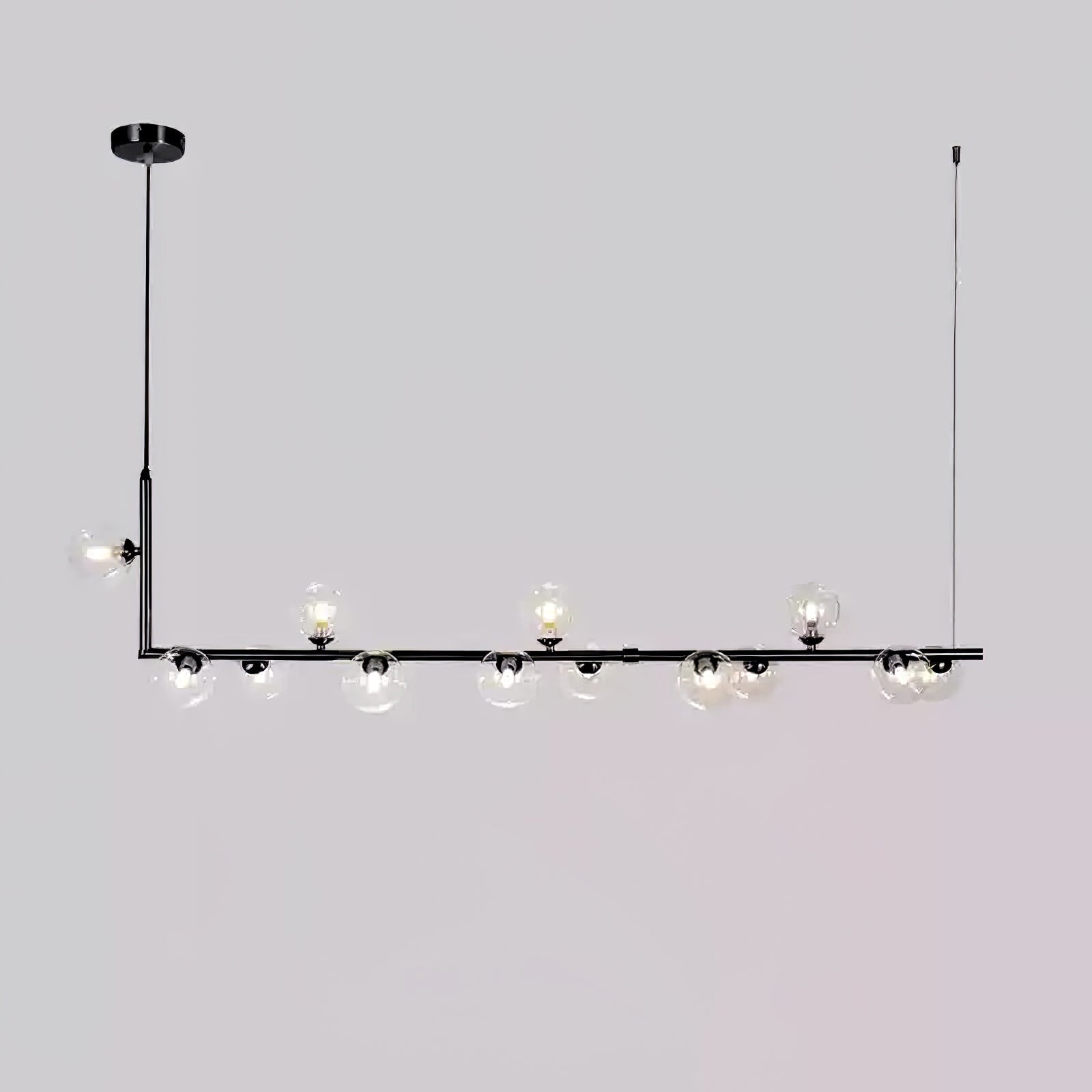 Clear glass pendant light close-up showing globe and steel join