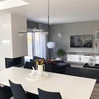 Clear glass globe pendant light on a right-angle steel structure