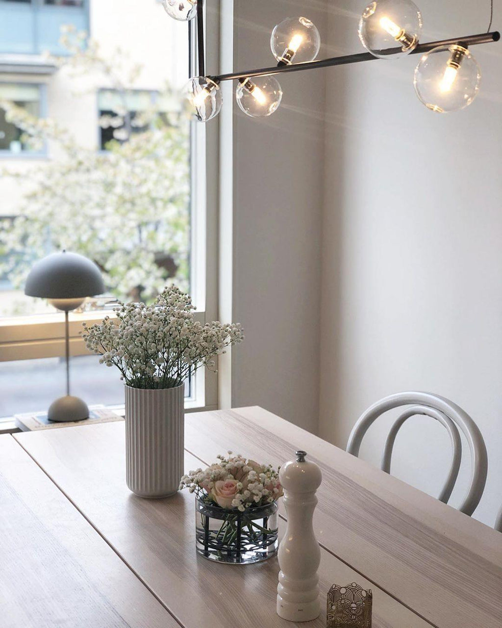 Glass sphere pendant light illuminated in a contemporary interior
