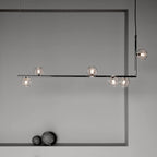 Glass globe pendant light glowing warmly in a styled room