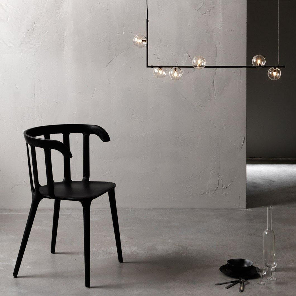 Geometric glass pendant light over a dining table setting