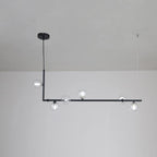 Clear glass sphere pendant light glowing above a dining table
