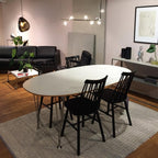 Glass globe pendant light with steel frame against neutral decor
