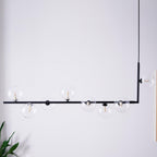 Clear glass globe pendant light hanging in a bright room