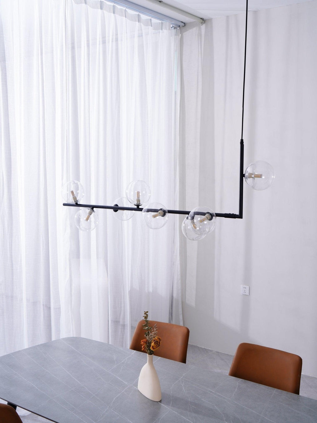 Glass sphere pendant light with warm lit globes