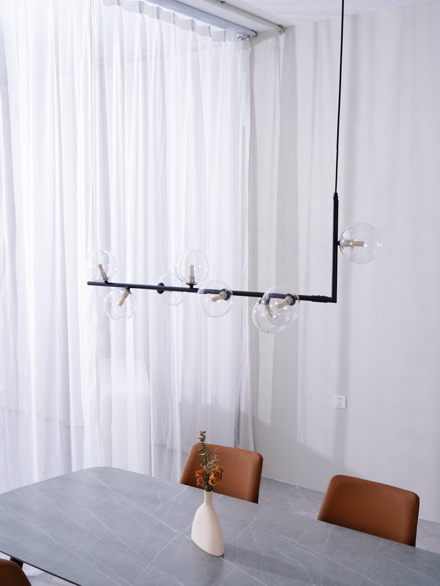 Glass sphere pendant light with warm lit globes