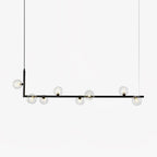 Glass globe pendant light hanging over a long table setting