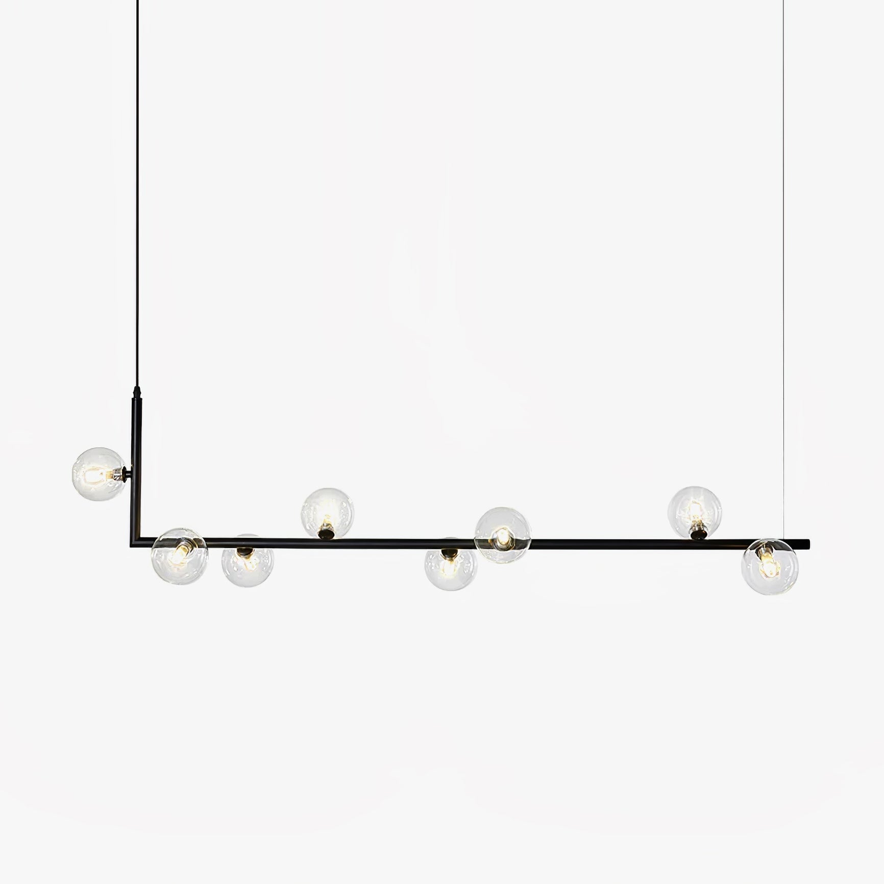 Glass globe pendant light hanging over a long table setting