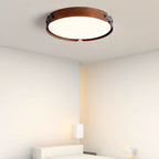 Wood-tone flush ceiling light in a minimal interior