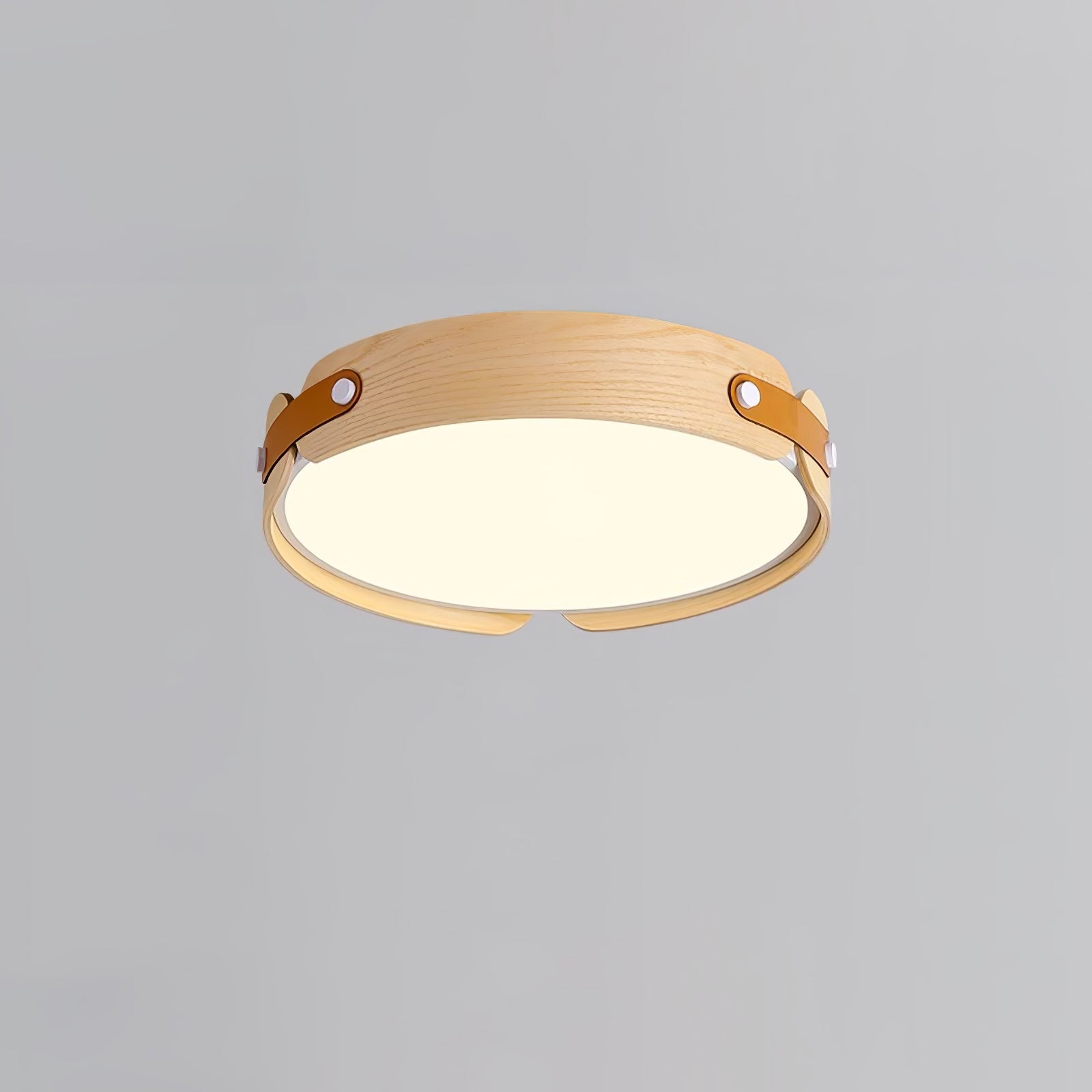 Round wood-finish flush ceiling light glowing softly overhead