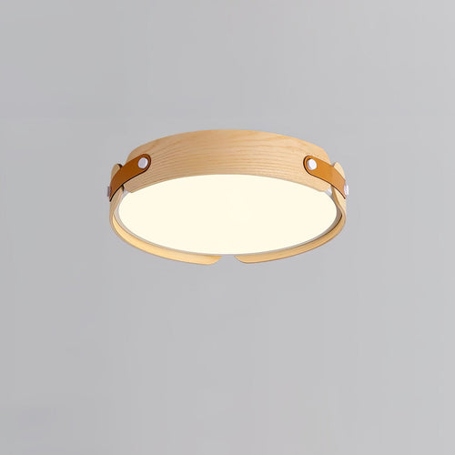Round wood-finish flush ceiling light glowing softly overhead