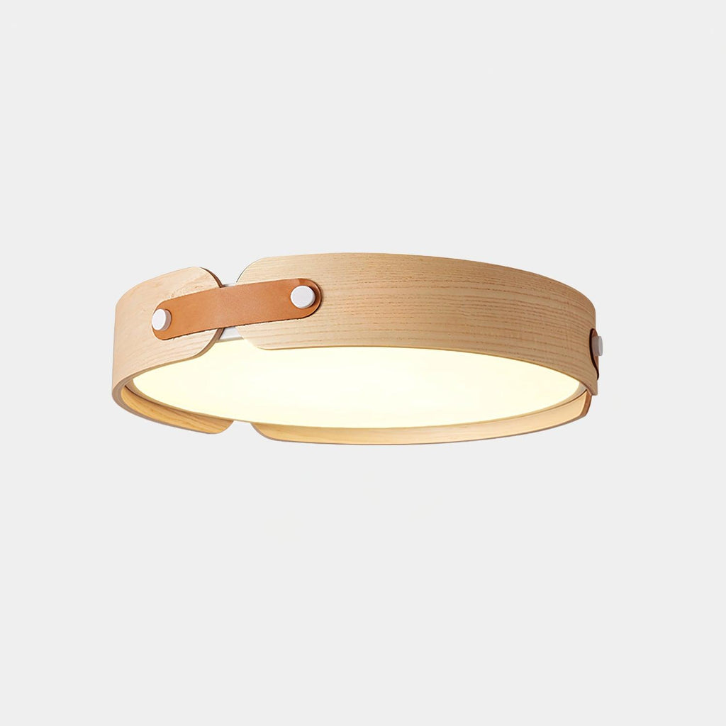 Wood-tone flush ceiling light lit warmly in a calm room