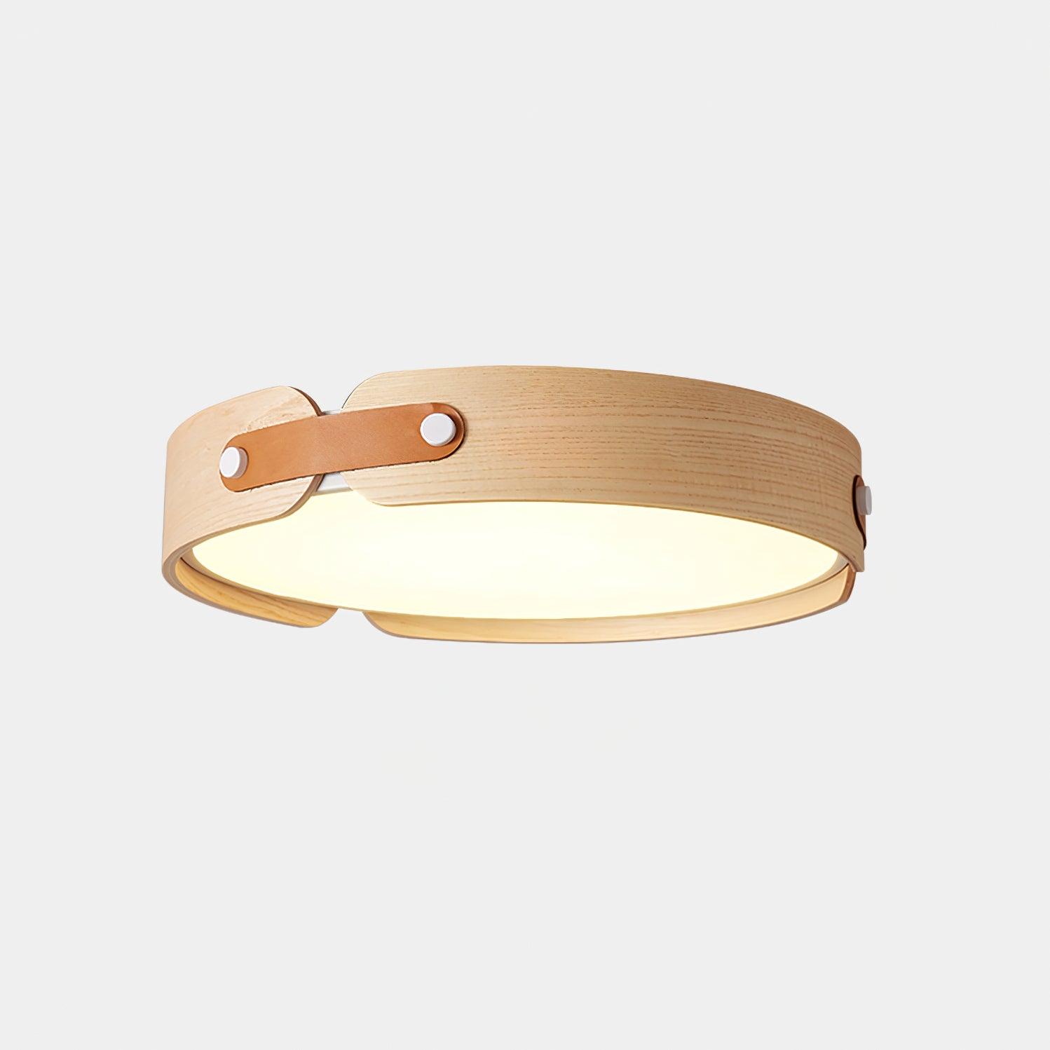 Wood-tone flush ceiling light lit warmly in a calm room