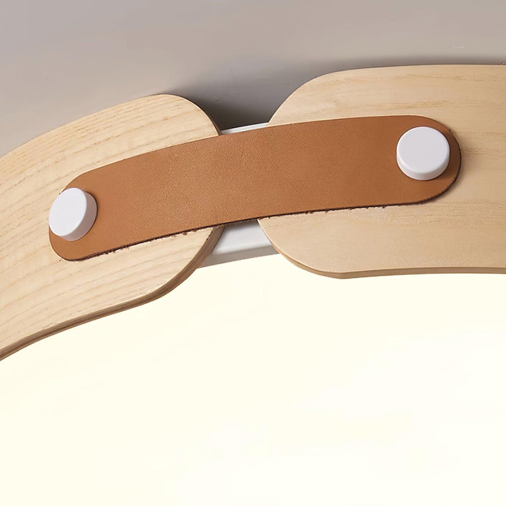 Round walnut ceiling light lit warmly overhead