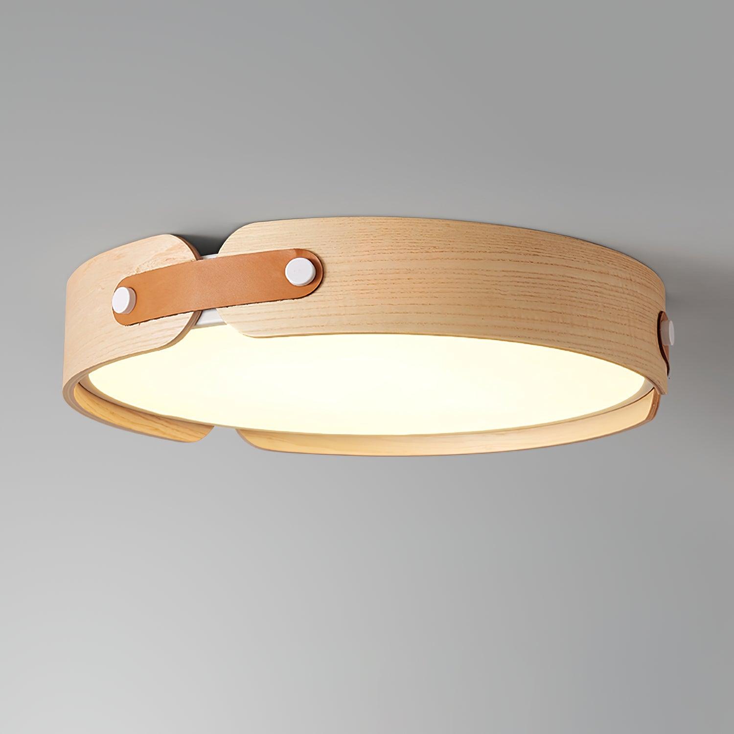 Round wooden ceiling light glowing softly at night