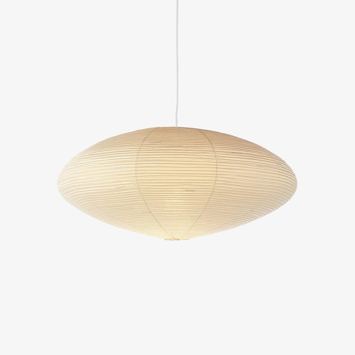 Single washi paper pendant light glowing in a quiet space