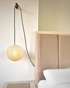 Round mulberry paper pendant light glowing softly