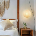 Paper globe swag pendant light with white cord draped