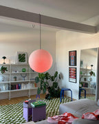 Paper globe swag pendant light on a white cord
