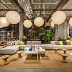 White paper globe pendant light hanging in a calm space