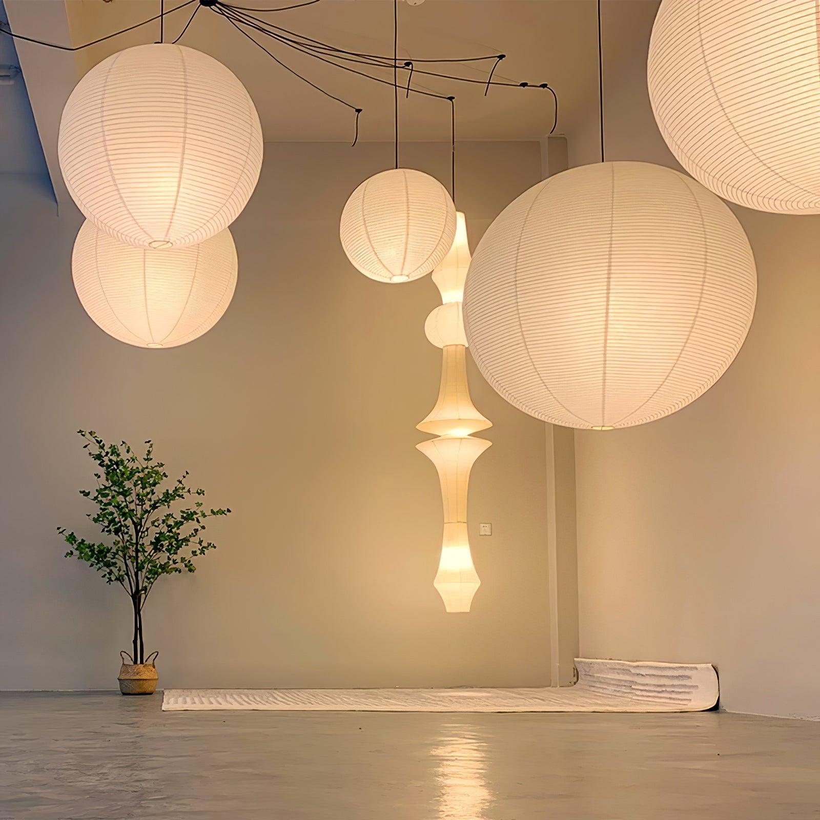 Paper globe swag pendant light draped on a white cord