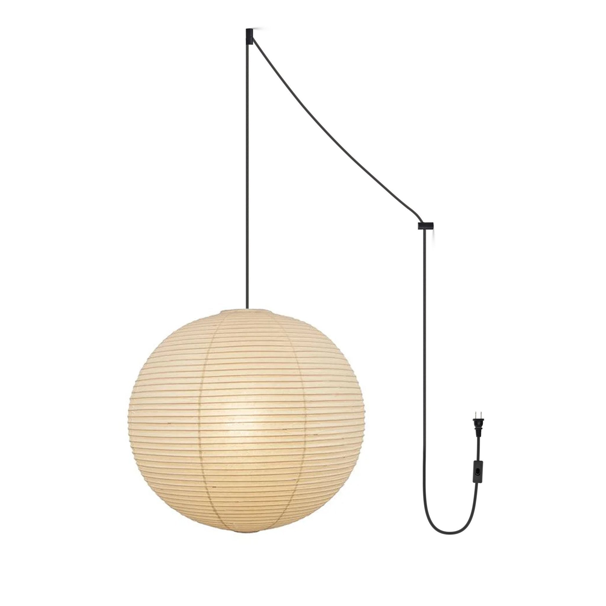 Round mulberry paper pendant light lit warmly in a room