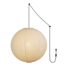 Paper sphere pendant light shown against a neutral wall