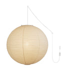 Round mulberry paper pendant light glowing in an interior
