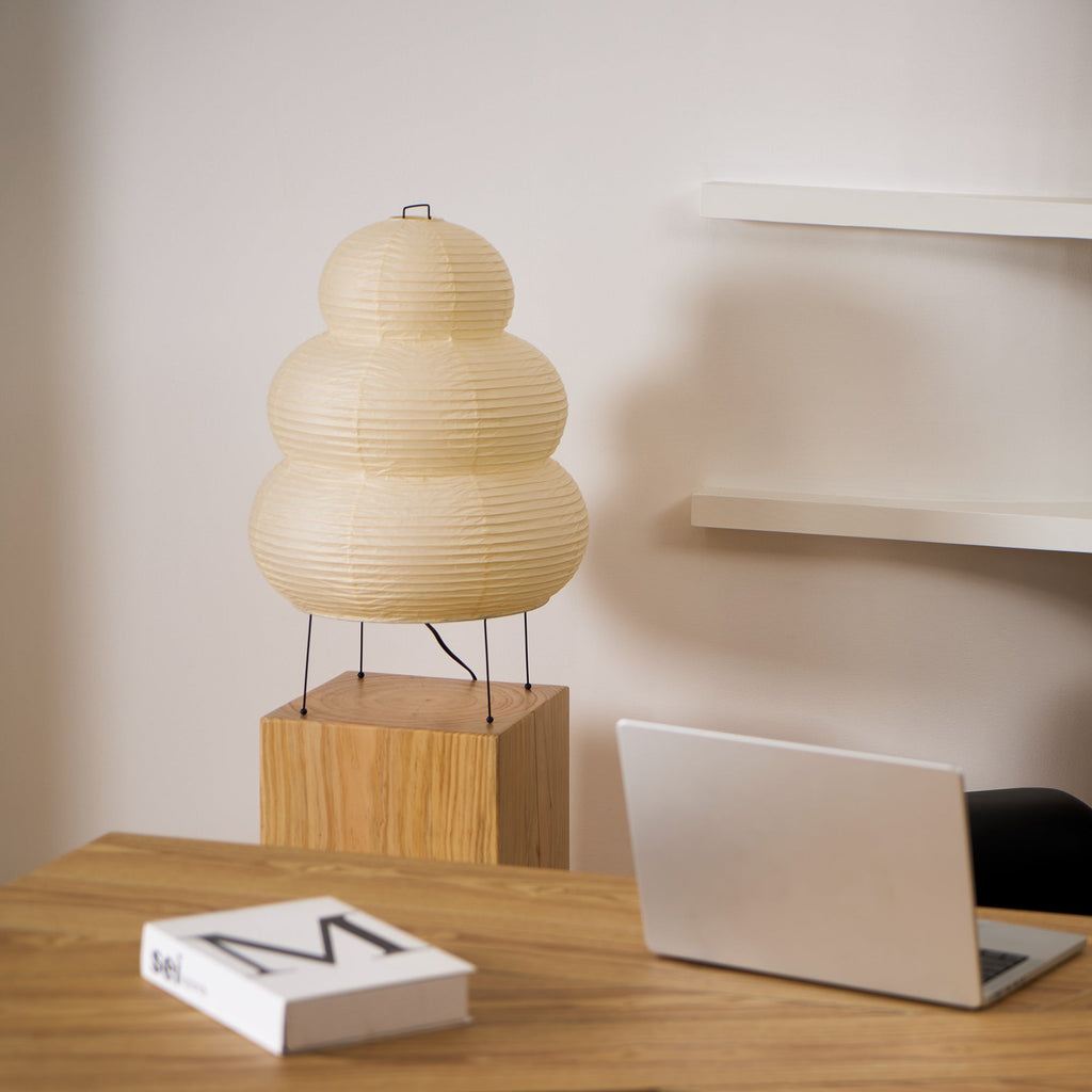 Paper lantern table lamp glowing softly in a warm interior