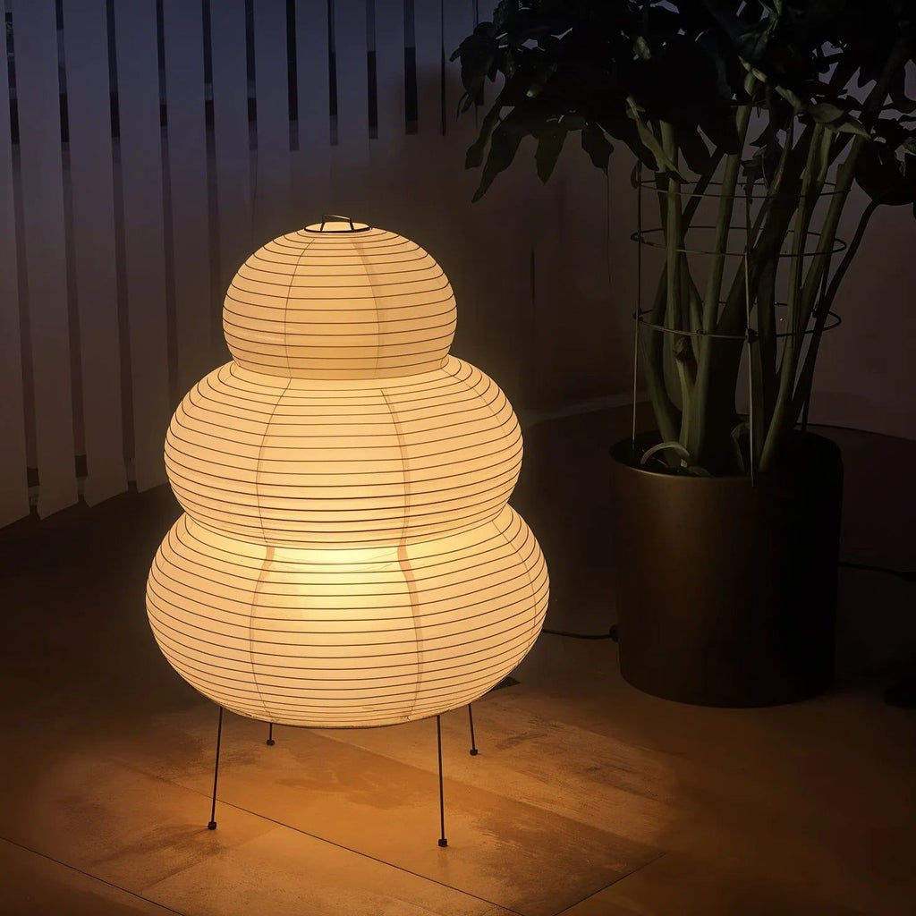 Handmade paper table lamp shown on a styled tabletop