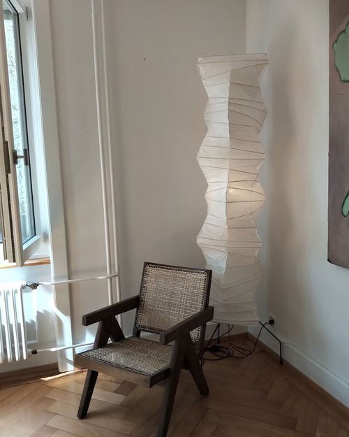 Akari floor lamp with ribbed paper shade in a calm interior