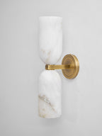Twin alabaster column wall light showing translucent stone glow