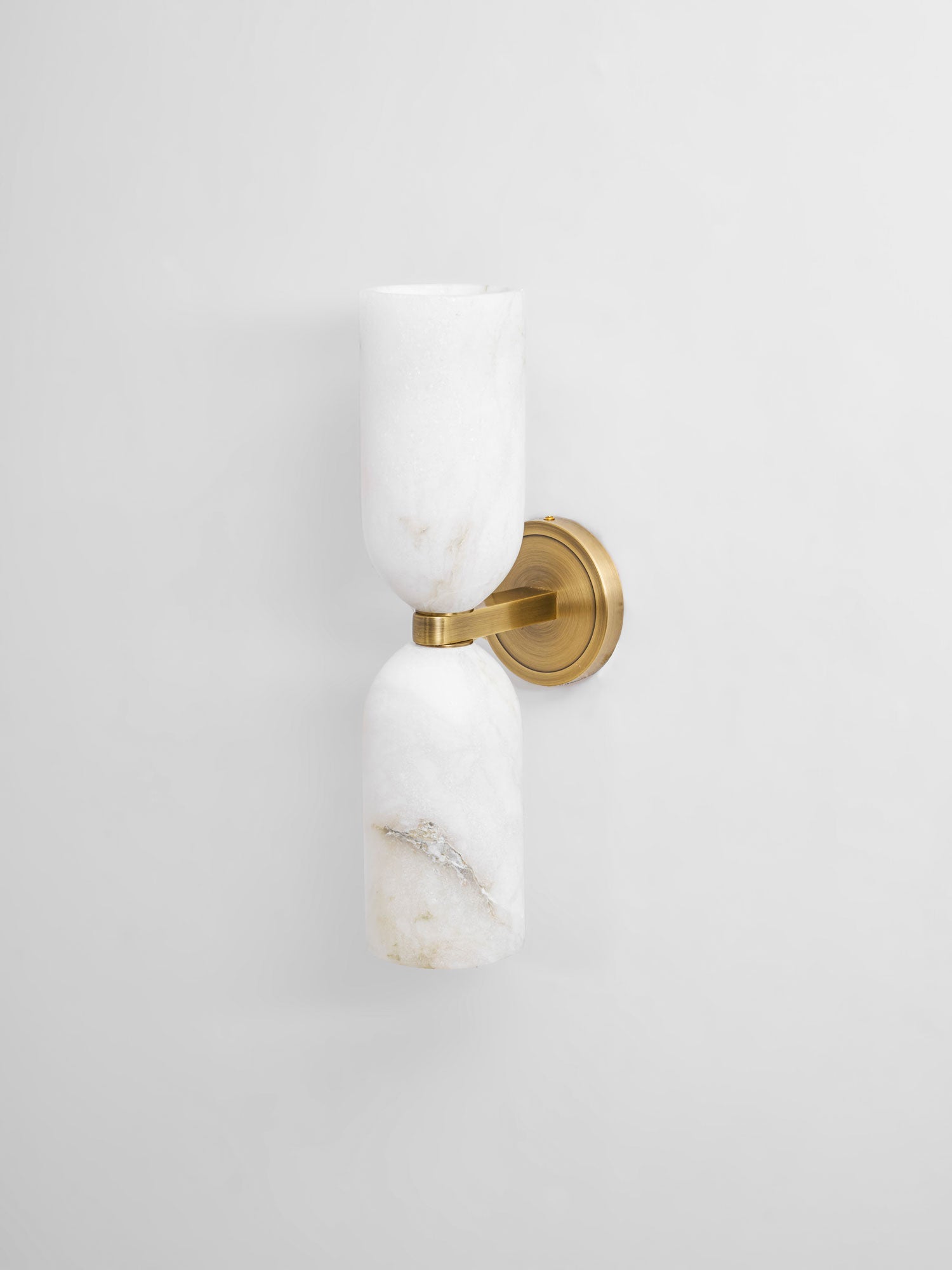 Alabaster wall sconce casting a gentle up and down wash of light