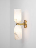 Unlit Nexus Modern Alabaster Wall Light mounted near a wall corner, seen from three quarters.