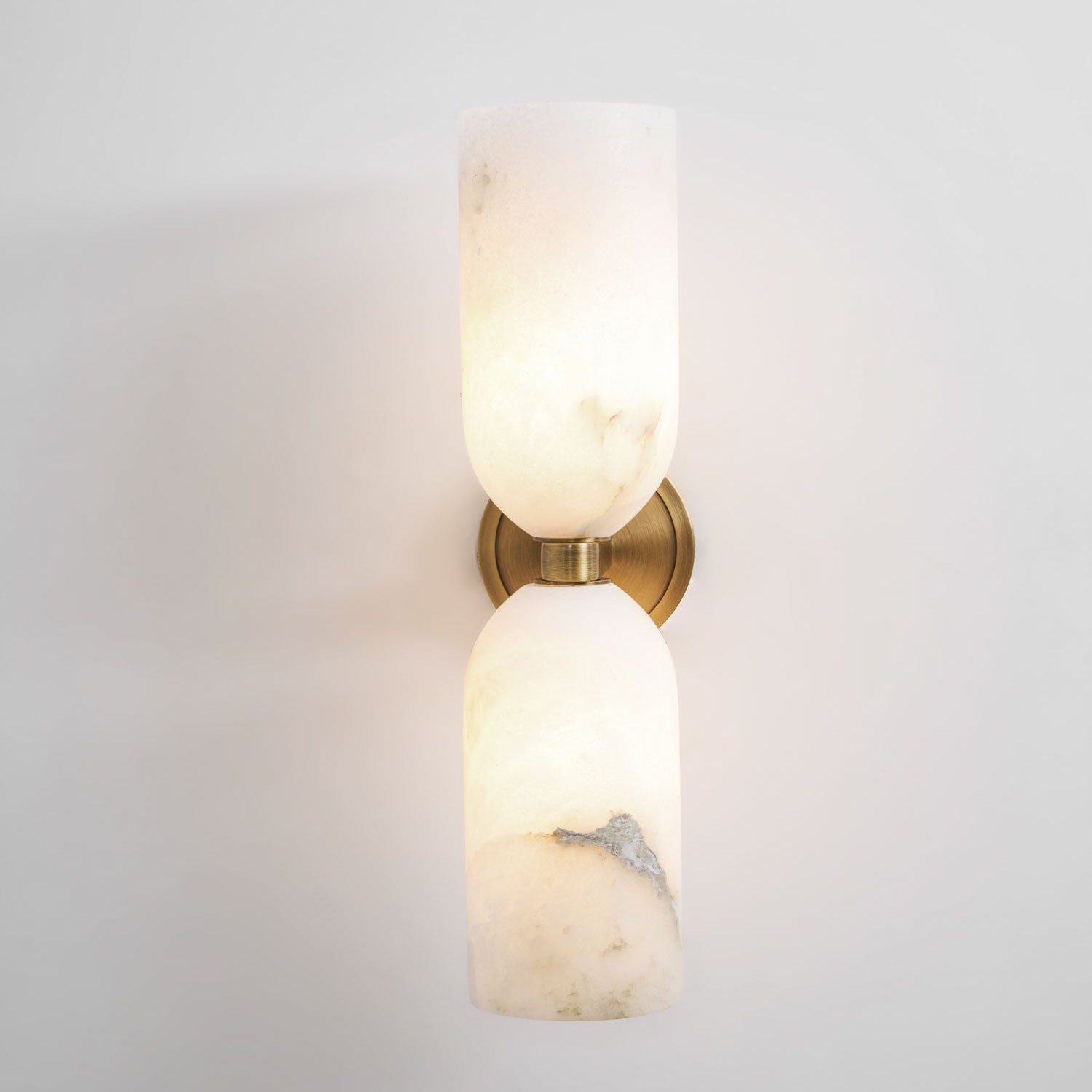 Alabaster nexus wall sconce casting a soft up and down glow