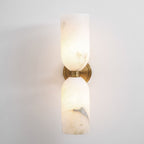 Square crop of the lit Nexus Modern Alabaster Wall Light, showing the veined lower shade and metal collar.