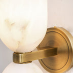 Natural alabaster columns with metal nexus on an interior wall