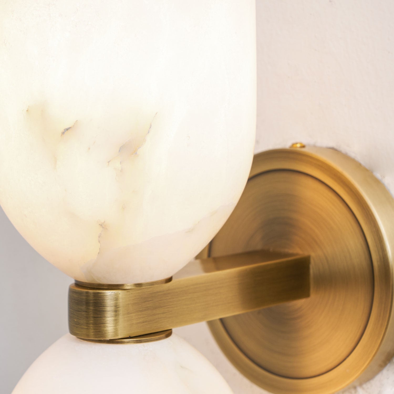 Natural alabaster columns with metal nexus on an interior wall