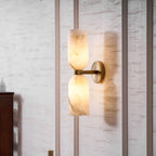 Symmetrical alabaster columns lighting a calm interior corner