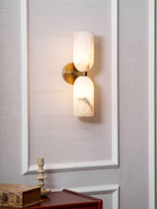 Natural alabaster sconce with bronze nexus and warm glow