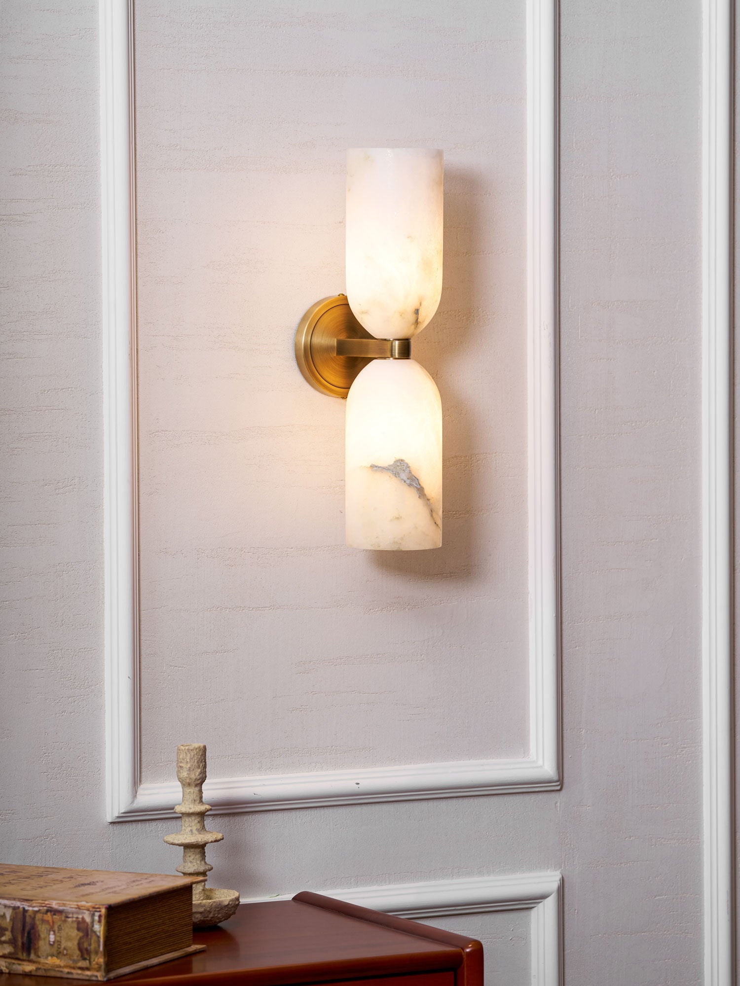 Natural alabaster sconce with bronze nexus and warm glow