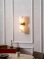 Natural alabaster columns with metal band casting gentle light