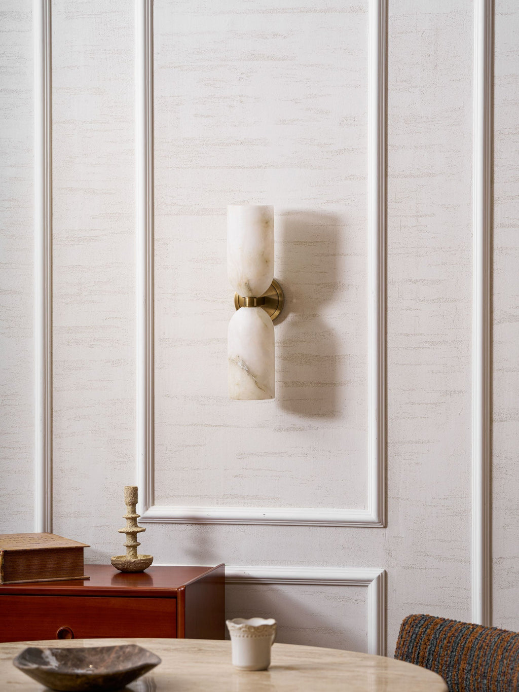 Nexus Modern Alabaster Wall Light switched off, its pale stone shades reading as soft white in daylight.