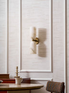 Twin alabaster column sconce casting soft symmetrical light