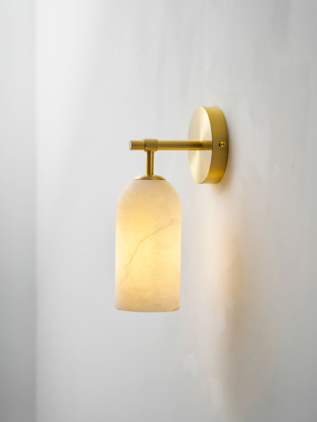 Sculptural alabaster wall sconce showing stone translucency and light
