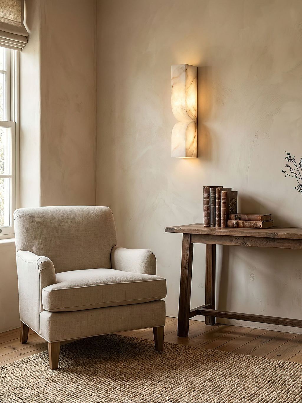 Carved alabaster sconce casting gentle ambient light on the wall